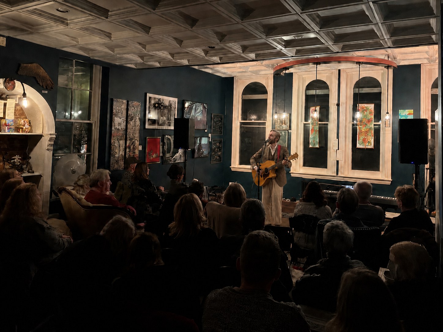 An audience watching Robert Rosina perform in an intimate venue