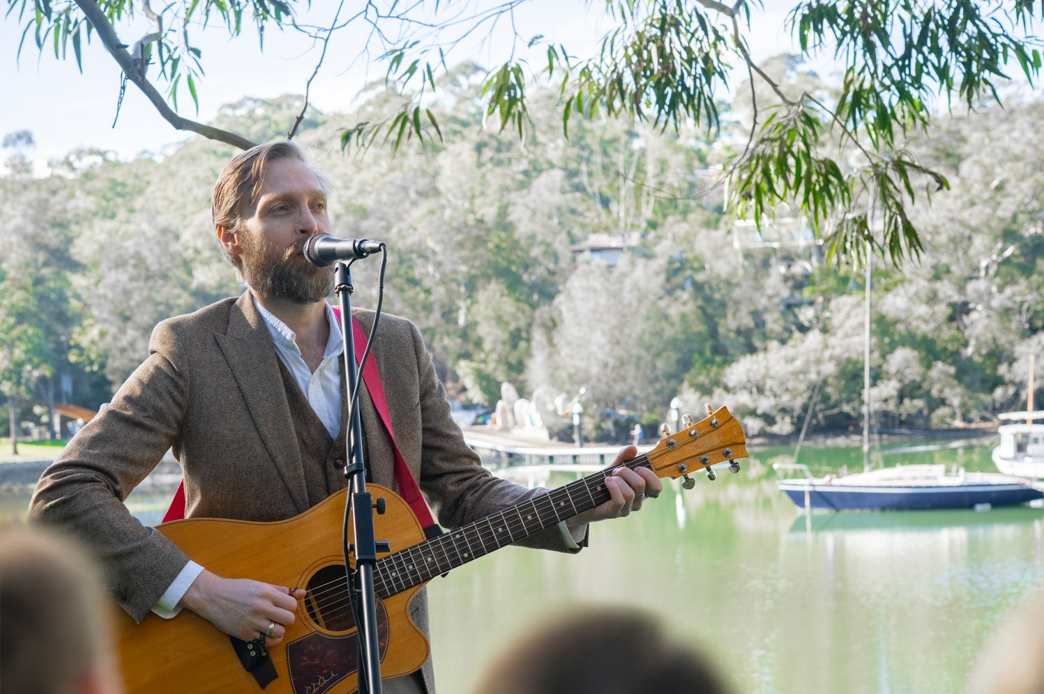 Robert Rosina performing outdoors beside the water
